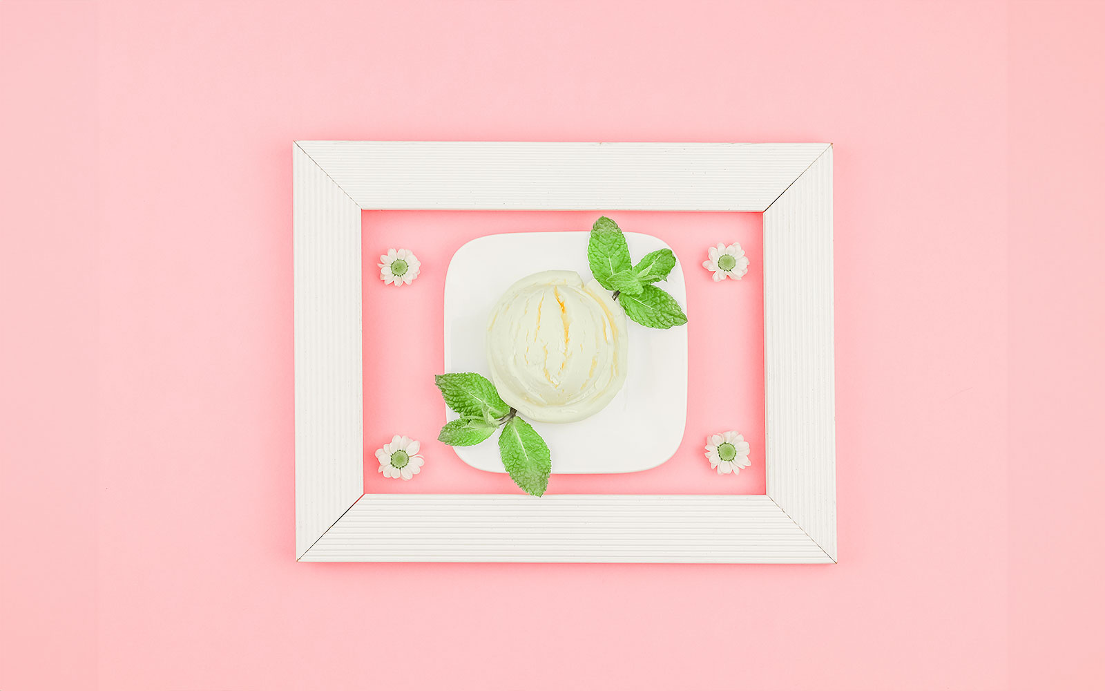 Ice cream scoop with mint leaves on a plate at Singapore's Museum of Ice Cream.