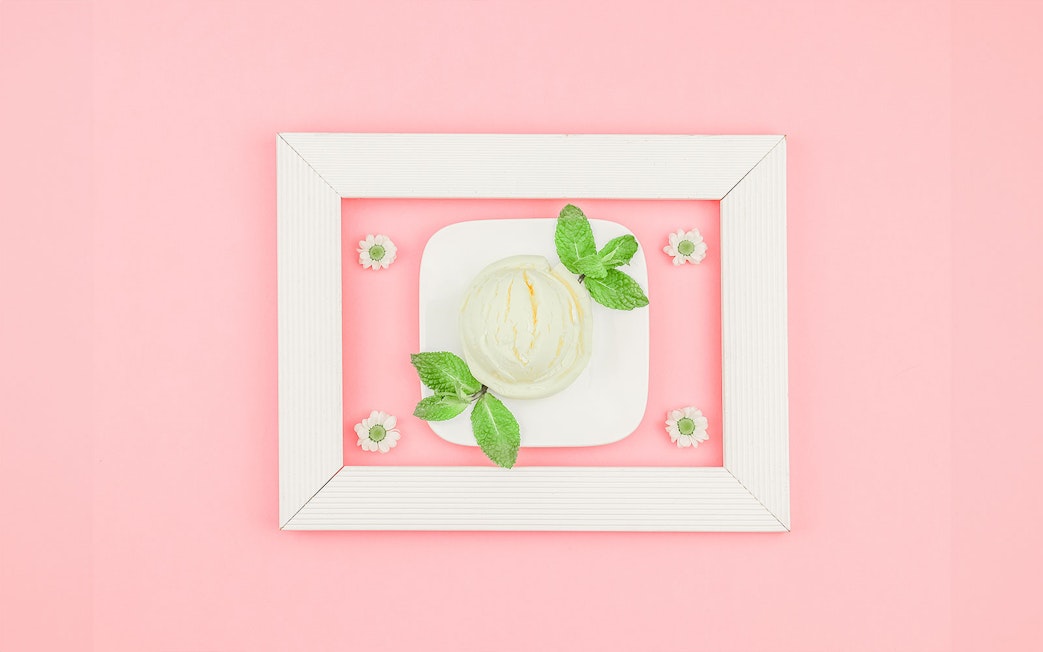 Ice cream scoop with mint leaves on a plate at Singapore's Museum of Ice Cream.