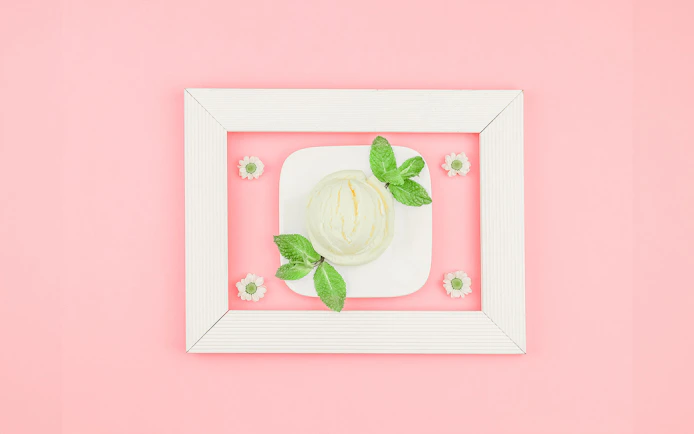 Ice cream scoop with mint leaves on a plate at Singapore's Museum of Ice Cream.