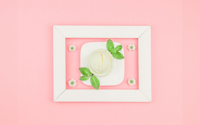 Ice cream scoop with mint leaves on a plate at Singapore's Museum of Ice Cream.