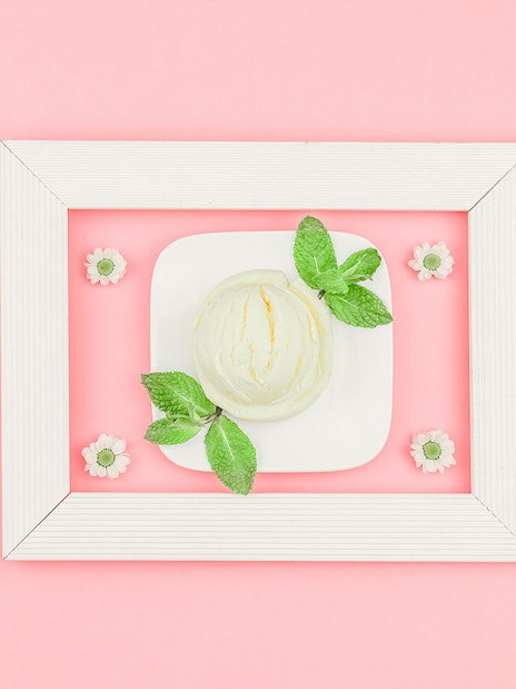 Ice cream scoop with mint leaves on a plate at Singapore's Museum of Ice Cream.