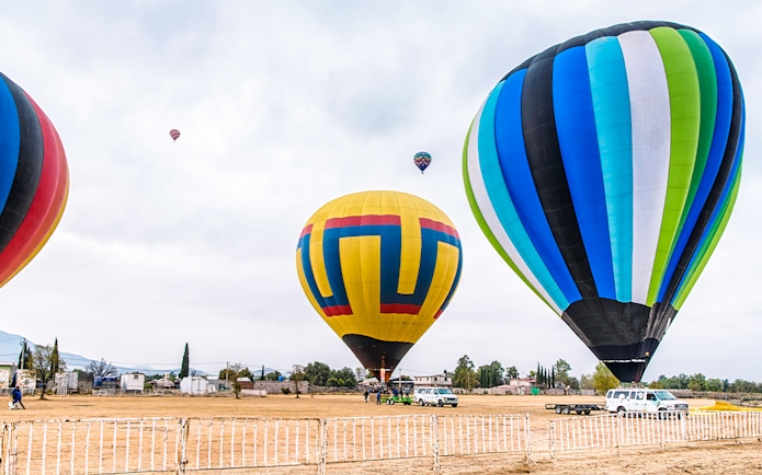 Hot air balloons being prepared for flight at Teotihuacan, Mexico.