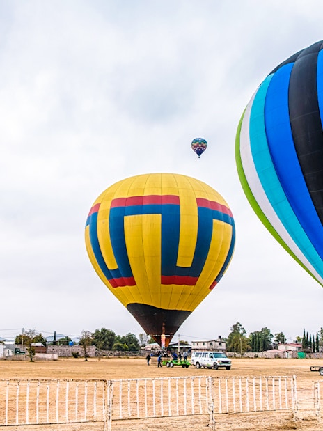 Hot air balloons being prepared for flight at Teotihuacan, Mexico.