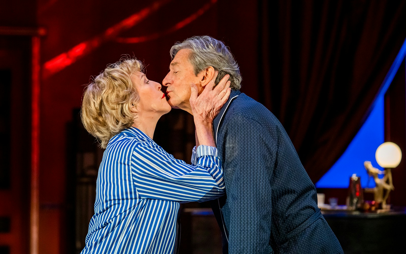 Couple kissing on stage during "Private Lives" performance.