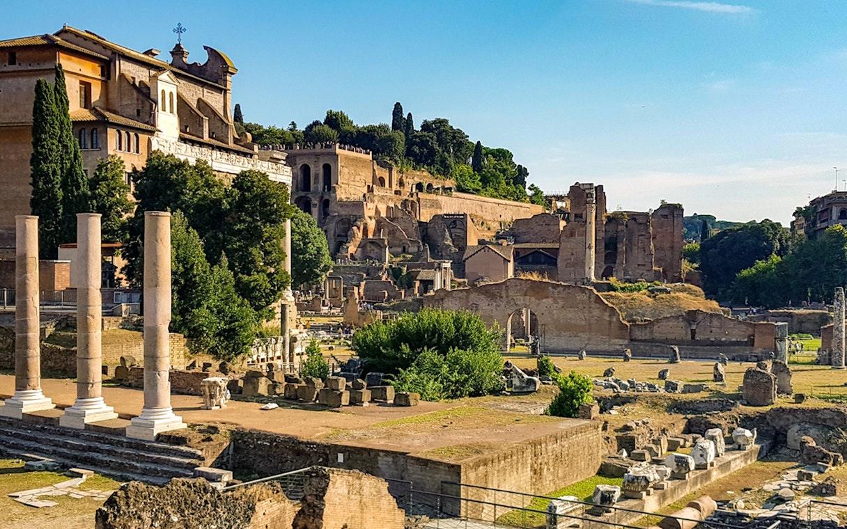 Roman Forum ruins with ancient columns and structures, part of the Colosseum virtual reality tour in Rome.