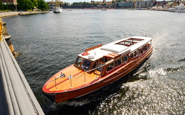 Classic wooden boat touring Stockholm Archipelago.