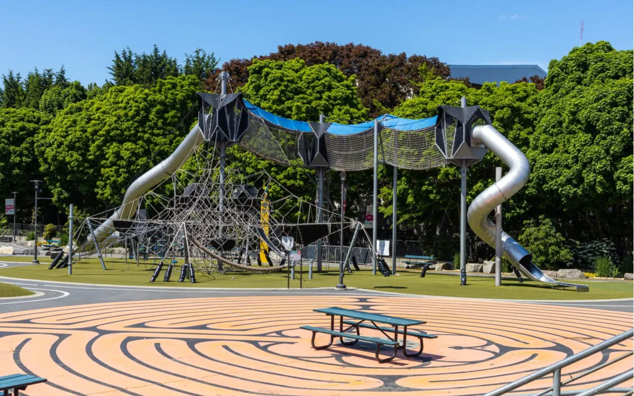 Playground with climbing structure and slides in Seattle park.