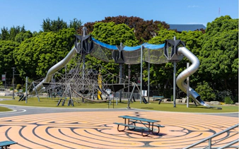 Playground with climbing structure and slides in Seattle park.