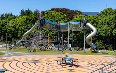 Playground with climbing structure and slides in Seattle park.