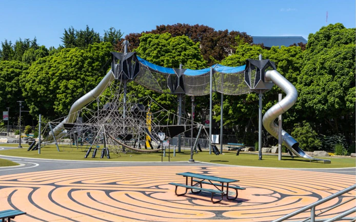 Playground with climbing structure and slides in Seattle park.
