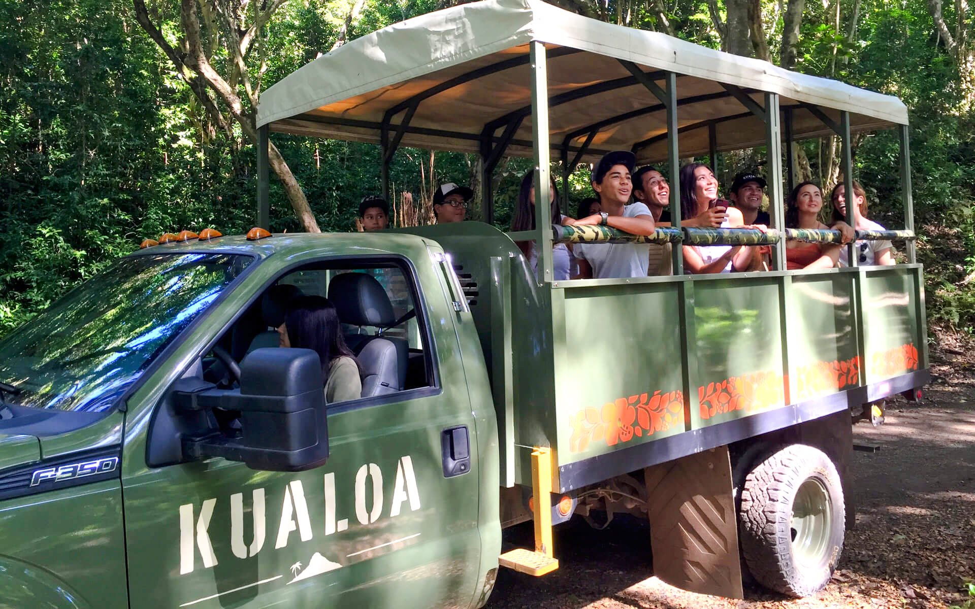 UTV tour group exploring Kualoa Ranch, Hawaii in an open-air vehicle.