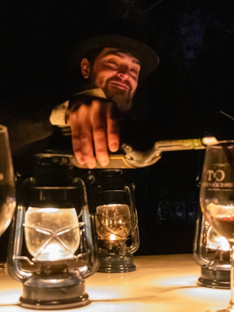 Wine tasting at Concha y Toro vineyard, person pouring wine into glasses.