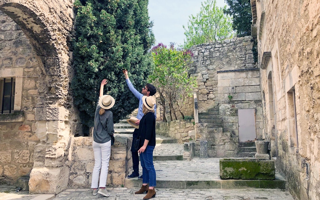 Tourists exploring historic stone architecture in Provence, France.