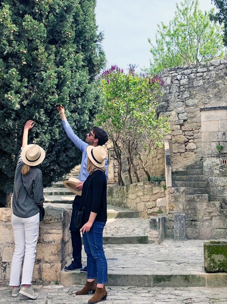 Tourists exploring historic stone architecture in Provence, France.