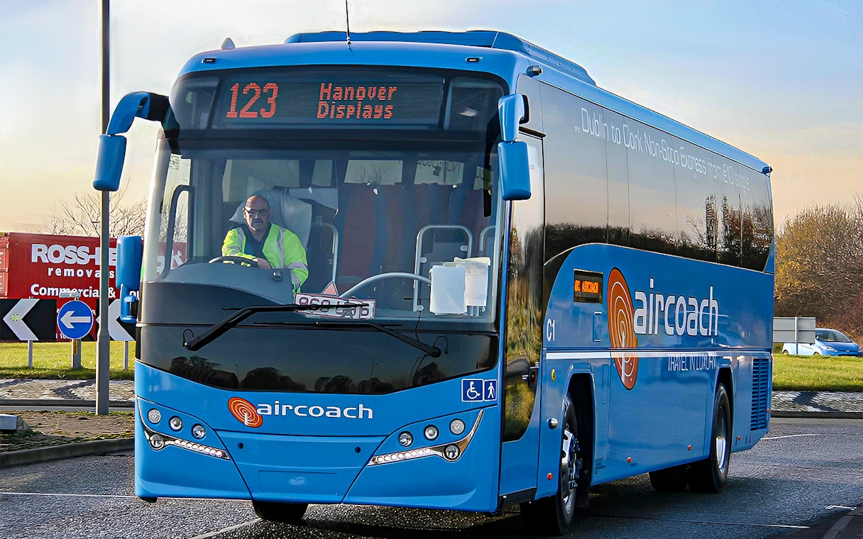 Dublin Aircoach bus for airport transfers on a city road.