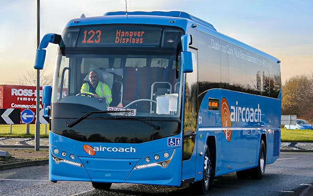 Dublin Aircoach bus for airport transfers on a city road.
