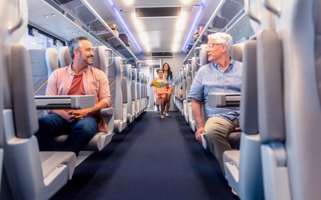 Passengers seated inside the Brightline train from Miami to Orlando.