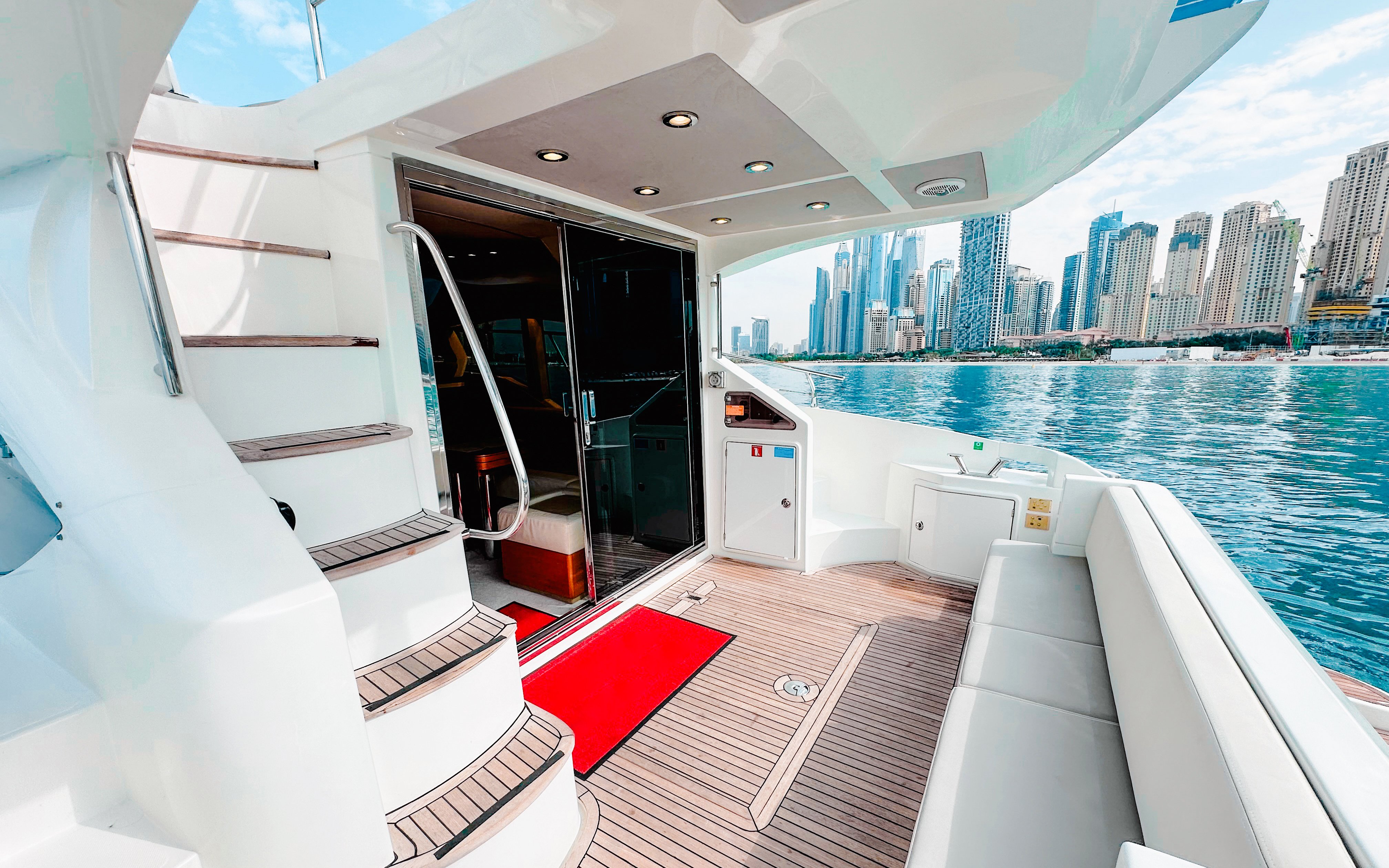 Inside view of a luxury yacht with Dubai skyline in the background.
