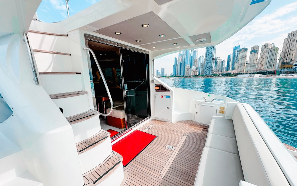Inside view of a luxury yacht with Dubai skyline in the background.