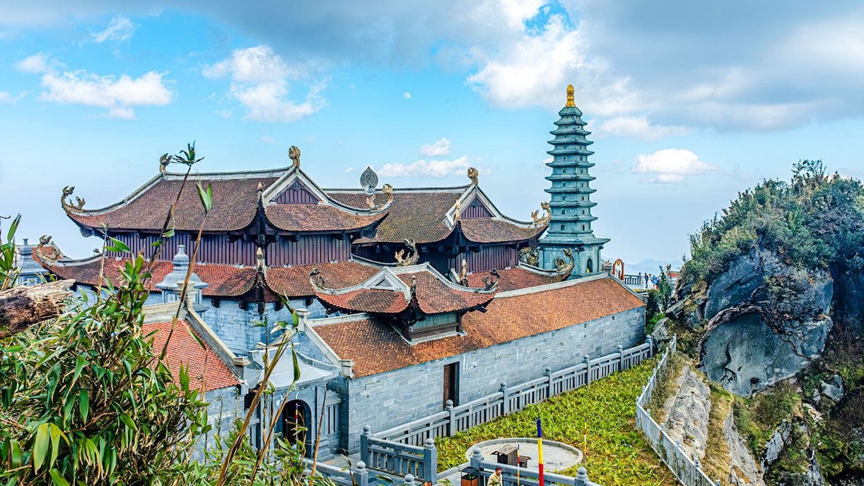 Fansipan Kim Son Bao Thang Pagoda with ornate roof and stone tower in Vietnam.