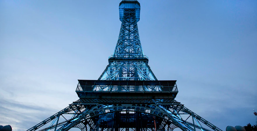 Replica of the Eiffel Tower at King's Island, Six Flags, against a twilight sky.