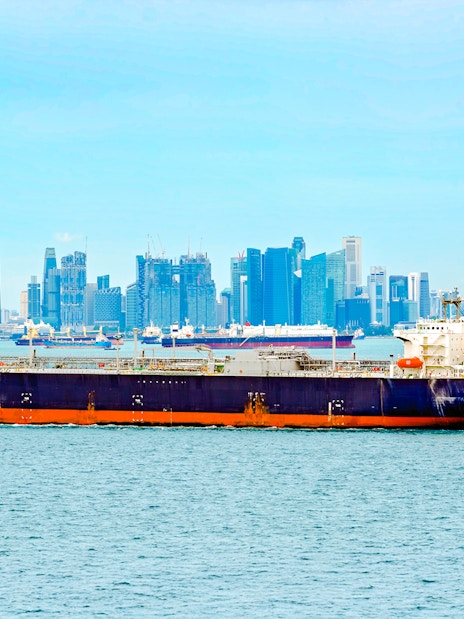 LPG tanker sailing through Singapore Strait with city skyline in background.