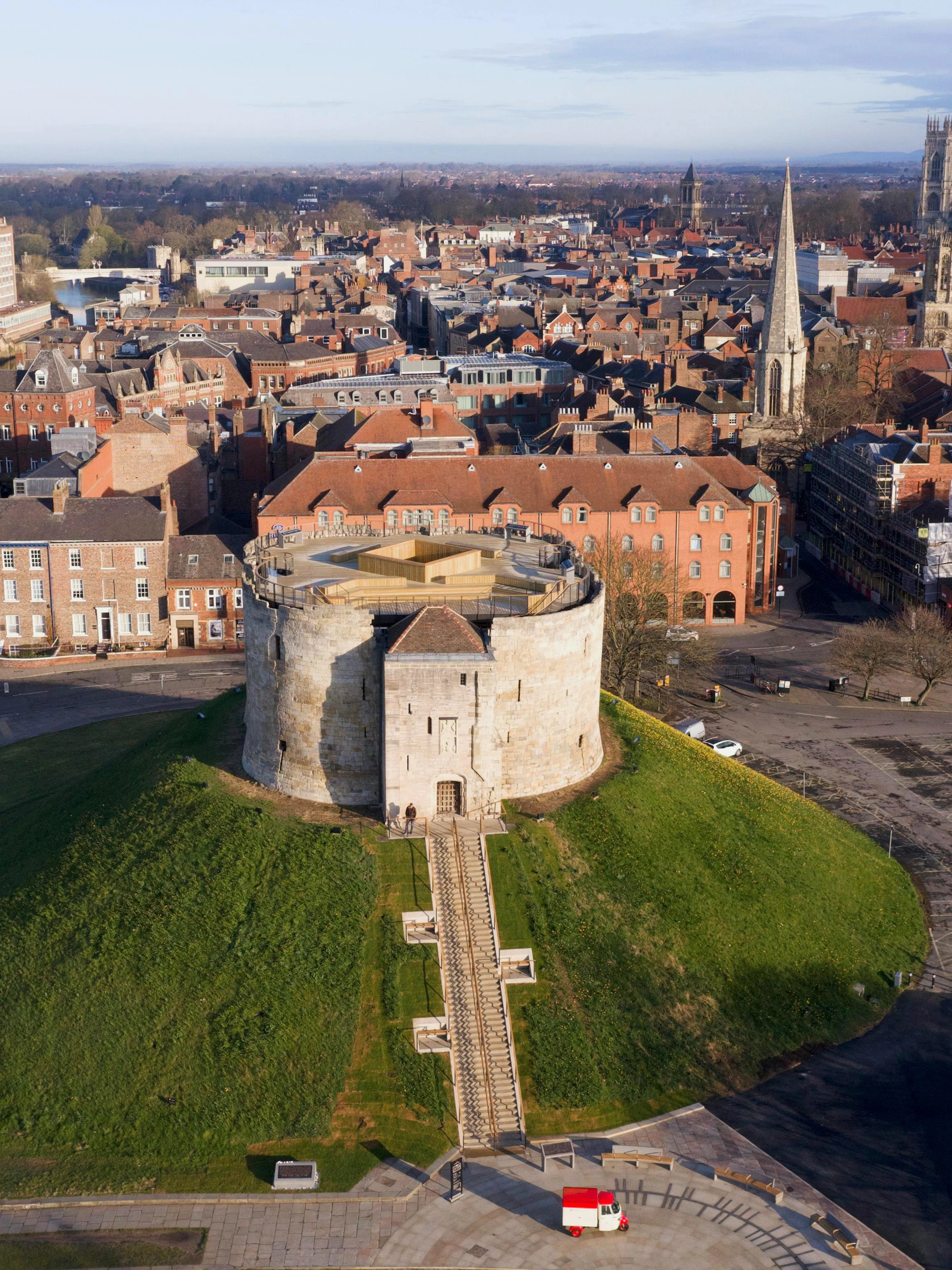 Clifford's Tower in York, England, surrounded by historic cityscape.