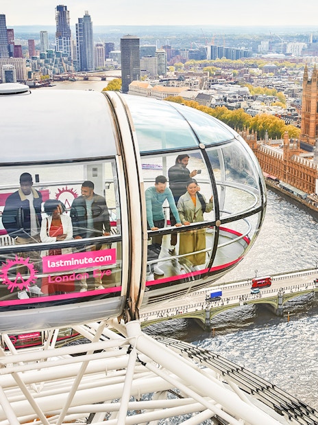 Visitors inside a London Eye capsule overlooking the River Thames and Big Ben.