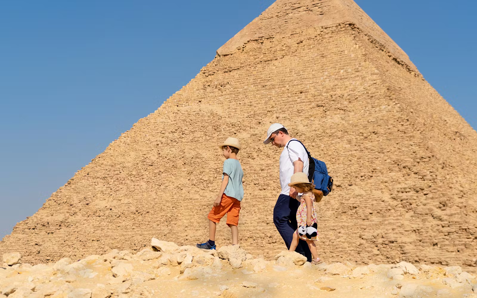 Family exploring pyramids on Cairo day trip from Hurghada.