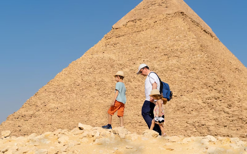Family exploring pyramids on Cairo day trip from Hurghada.