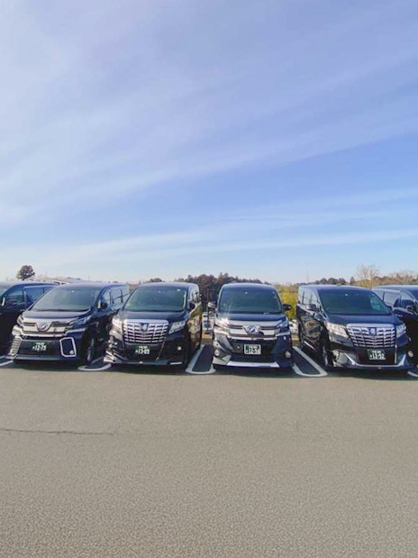 Private transfer vehicles for Tokyo Disney Resort in a parking lot.