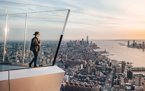Person standing on New York's Edge Observation Deck with city skyline and Hudson River view.