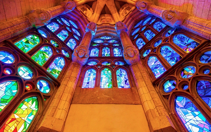 Stained glass windows inside Sagrada Familia, Barcelona, showcasing vibrant colors and intricate designs.