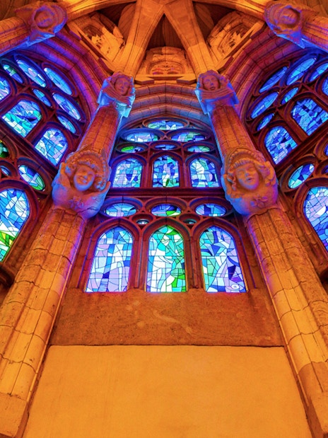 Stained glass windows inside Sagrada Familia, Barcelona, showcasing vibrant colors and intricate designs.
