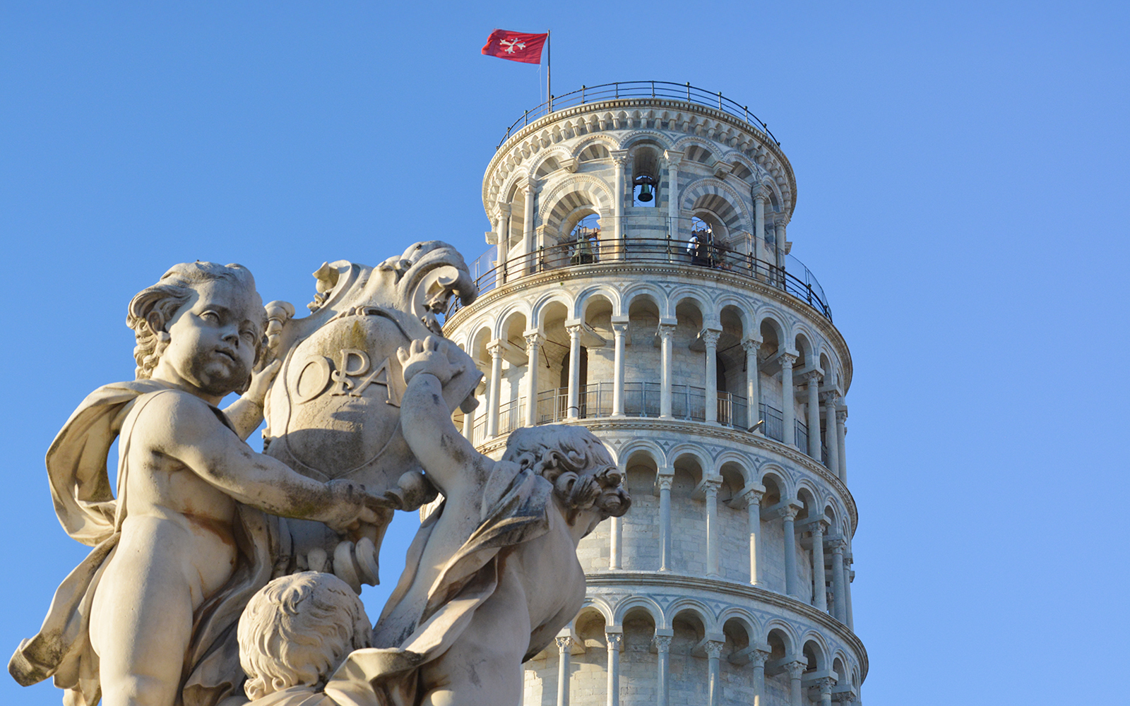 Fountain of the Putti with Leaning Tower of Pisa in background, Pisa, Italy.