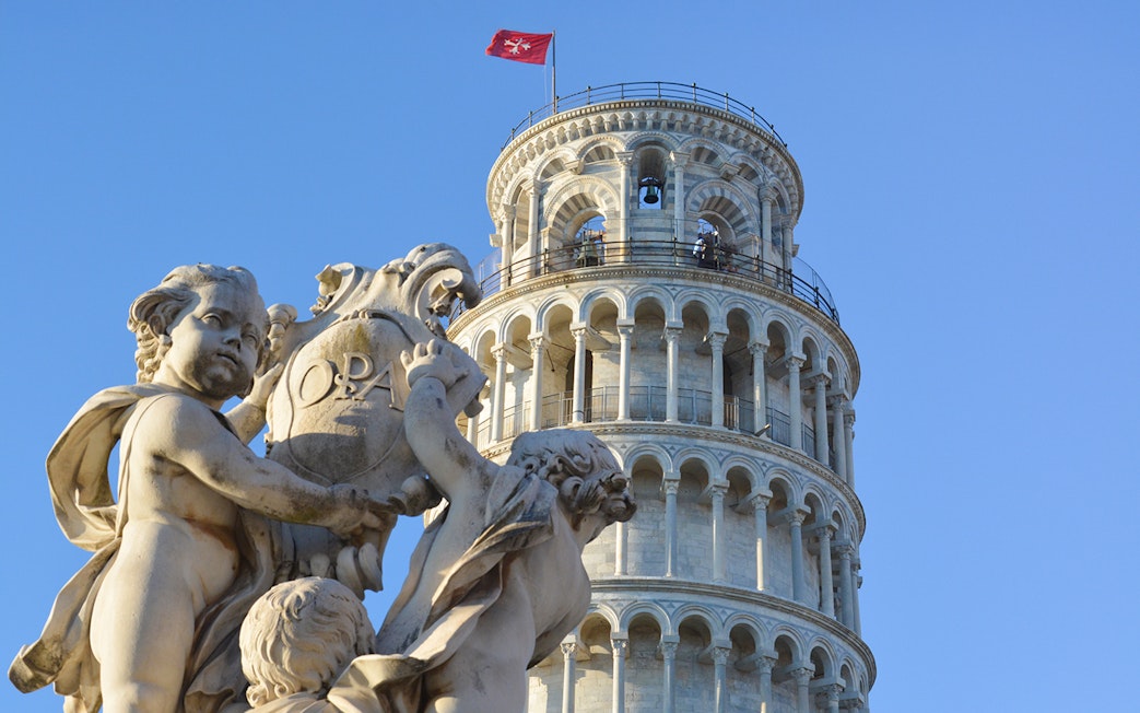 Fountain of the Putti with Leaning Tower of Pisa in background, Pisa, Italy.
