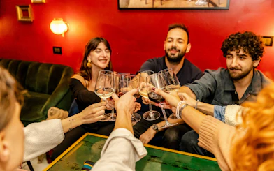 Guests toasting with wine glasses at the Tipsy Tour in Rome.