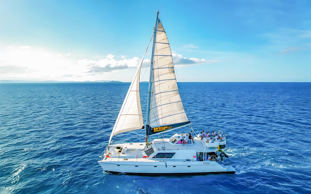 Tourists on a chartered catamaran sailing in the Whitsundays.