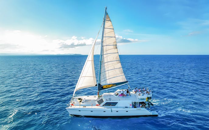 Tourists on a chartered catamaran sailing in the Whitsundays.