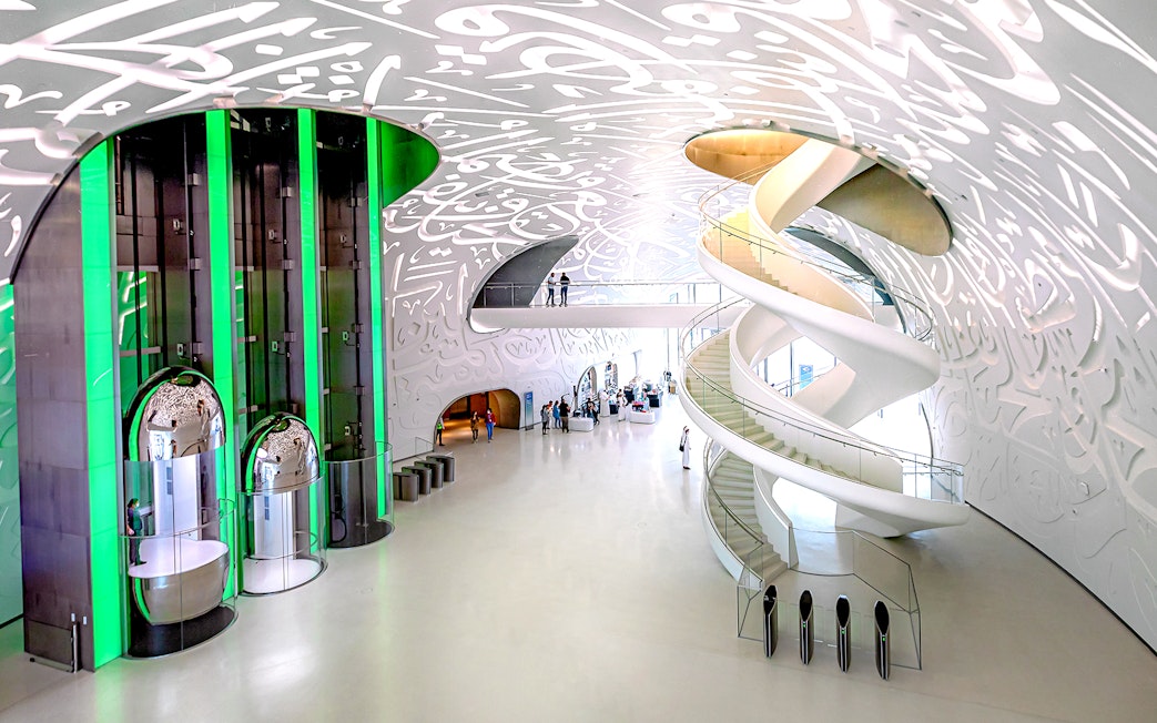 Interior of Museum of The Future in Dubai with spiral staircase and Arabic calligraphy.