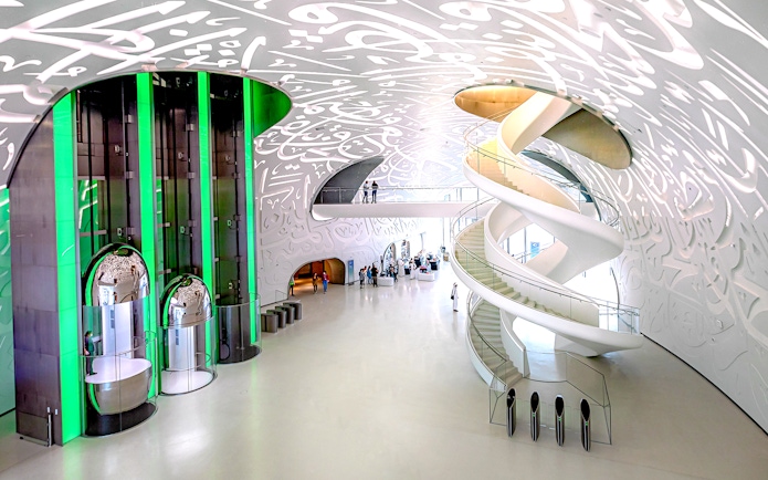 Interior of Museum of The Future in Dubai with spiral staircase and Arabic calligraphy.