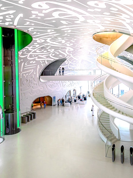 Interior of Museum of The Future in Dubai with spiral staircase and Arabic calligraphy.