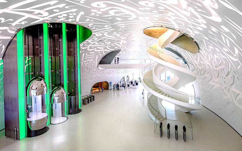 Interior of Museum of The Future in Dubai with spiral staircase and Arabic calligraphy.