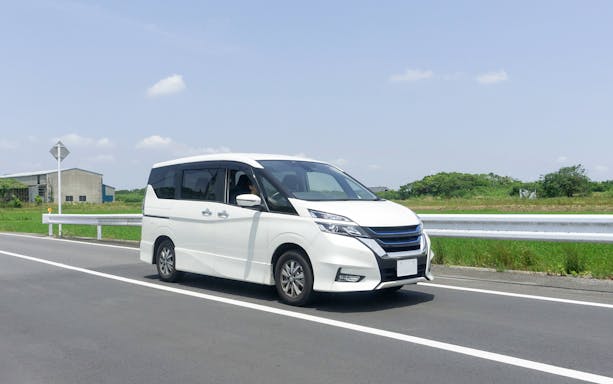 White van on road for Haneda Airport transfer service.