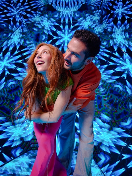 Guests enjoying kaleidoscopic room at Paradox Museum London.