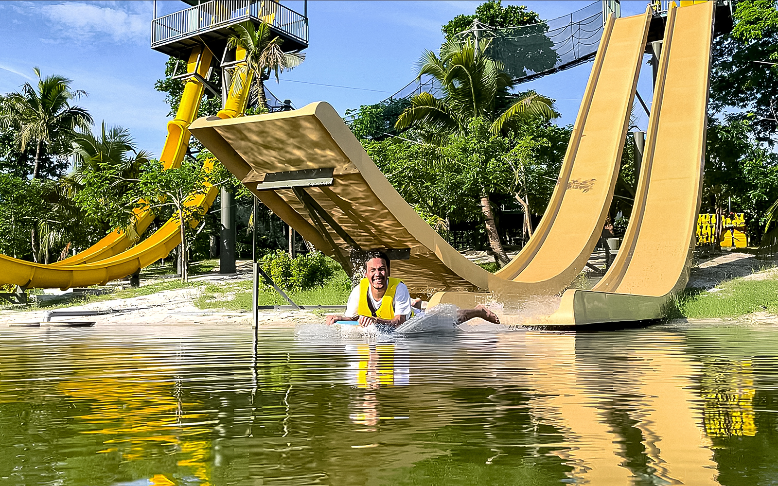 Man sliding down a water slide at ESCAPE Ipoh Theme Park, Malaysia.