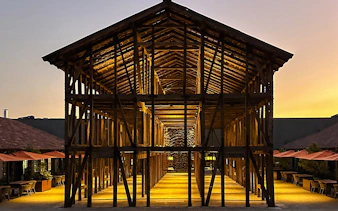 Concha y Toro Winery's illuminated wooden structure at sunset, Santiago.