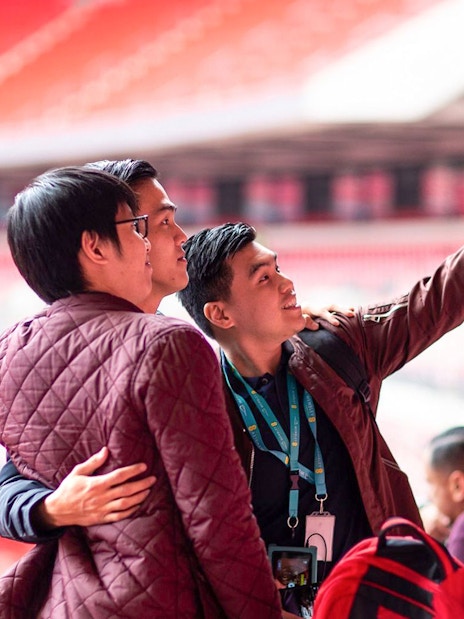 Visitors taking a selfie inside Wembley Stadium.