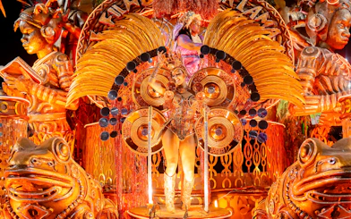 Performer in elaborate costume on a float at Rio Carnival 2027, Marquês de Sapucaí, Rio de Janeiro.
