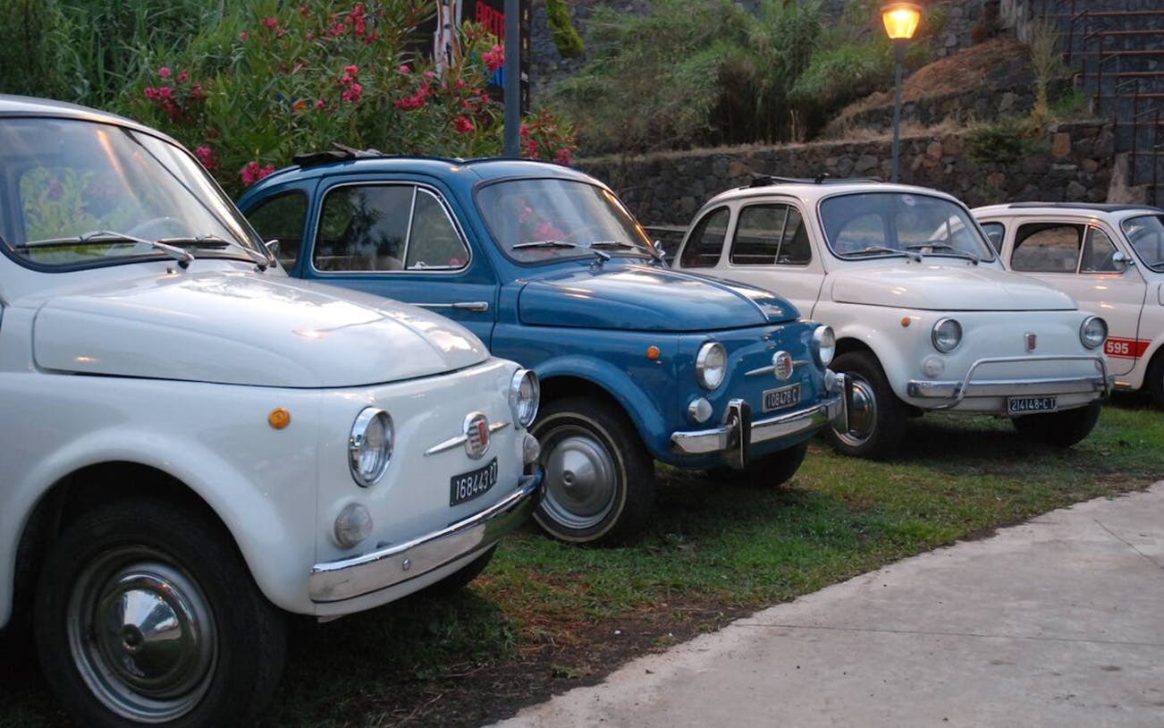 Vintage Fiat cars lined up for Riviera of the Cyclops tour from Catania.